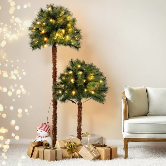 Decorative Christmas trees with lights in a living room setting.